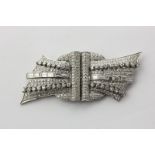 A diamond double clip brooch set throughout with graduated baguette and single cut diamonds