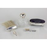 An Edward VII silver mounted small dressing table box, silver handled brush, smaller brush, and a
