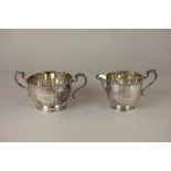 A George V silver milk jug with matched sugar bowl, makers Adie Brothers Ltd, Birmingham 1924 and