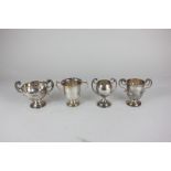 Four various early 20th century small silver twin handled trophy cups, including one by the