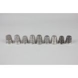 A collection of eight Victorian and later silver thimbles, various dates and makers, together with a