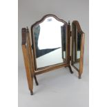 A Queen Anne style walnut framed adjustable dressing table mirror on outswept legs to scroll feet,