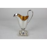 A modern silver neo-classical style cream jug with gilt interior, on square base, maker A Chick &