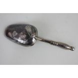 A Russian silver caddy spoon, the bowl with engraved floral decoration to back, impressed marks,