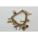A 9ct gold curb link bracelet hung with various charms, 23.5g