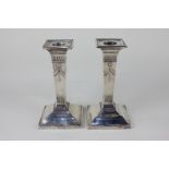 A pair of Edward VII silver dwarf column candlesticks with embossed swag and tassel design, maker