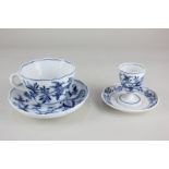 A Meissen porcelain blue and white cup and saucer with wavy edge and crossover handle, and an egg