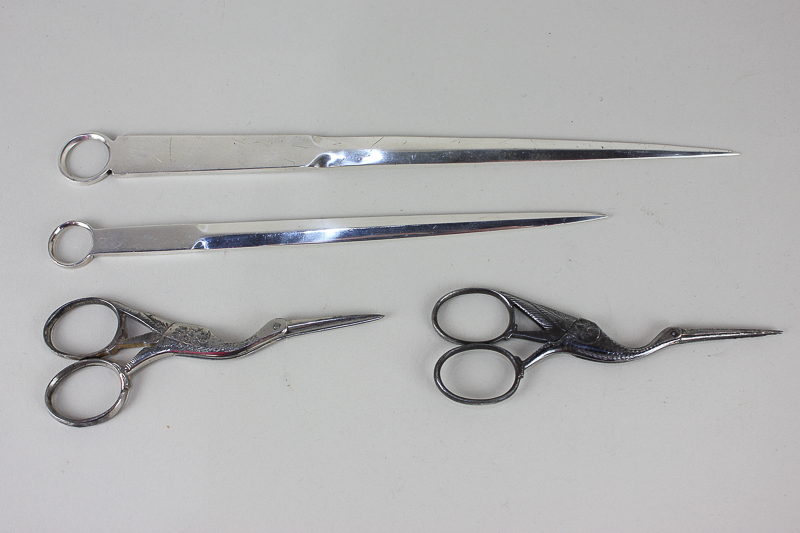 Two silver plated meat skewers, together with two silver plated scissors modelled as storks