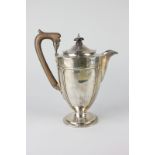 A George V silver pedestal hot water jug with hinged dome cover, on circular base, maker E S