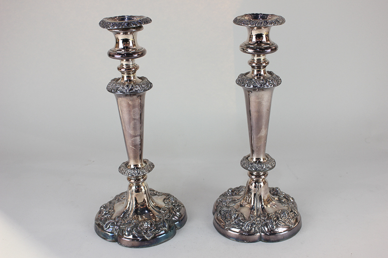 A pair of silver plated column candlesticks with embossed floral design, 28cm high