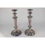 A pair of silver plated column candlesticks with embossed floral design, 28cm high