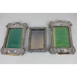 A pair of Art Nouveau silver mounted photograph frames with rectangular apertures and shaped borders