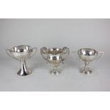 Three various George V silver twin handled trophy cups, including one with circular bowl on flared