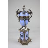 A silver and enamel 'pendule a cercle' the ovoid case on a triangular base gem and pearl set on a