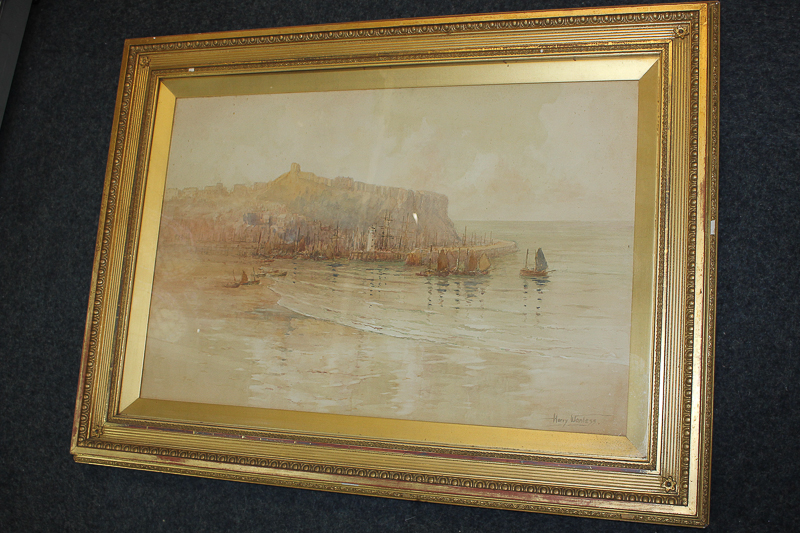 Harry Wanless (1873-1934), boats moored before a coastline, watercolour, signed, paper label for