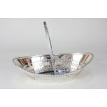 A late Victorian silver navette shaped cake basket with reeded swing handle and border, and