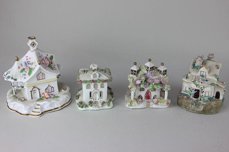 Four various Staffordshire pottery pastille burners modelled as cottages, to include one with