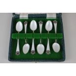 A cased set of six Norwegian silver gilt and white guilloche enamel tea spoons by David Andersen,