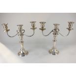 A pair of silver plated three-branch candelabra, 30cm high