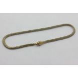 A 9ct gold necklace, the snake-head clasp with gem set eyes, 10g