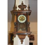 A Vienna style walnut wall clock with 14cm circular dial, enamel chapter ring, in glazed case with