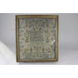 An early 19th century framed needlework verse sampler decorated with an arbour, flowers, foliage and