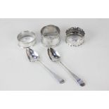 Three various early 20th century silver napkin rings, two with engraved initials, and a pair of