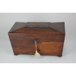 A 19th century rosewood sarcophagus shaped tea caddy with central well flanked by two lidded