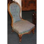 A Victorian button back nursing chair with scrolling foliated pierced surmount, purple and green