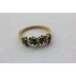 A diamond, sapphire and emerald ring in 18ct yellow gold