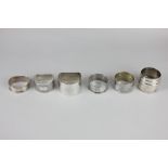Five George VI and later silver napkin rings and an 800 white metal napkin ring, 4oz gross