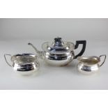 A silver plated three-piece tea set, oval shape with gadrooned border, including teapot, cream jug