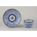 A late 18th century blue and white Worcester porcelain cup and saucer, with crossover handle,