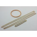 A 9ct gold bangle, two 9ct gold neck chains, and a bracelet, 22.9g