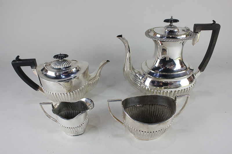 A three-piece silver plated tea set with matched hot water jug, of half reeded form