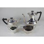 A three-piece silver plated tea set with matched hot water jug, of half reeded form