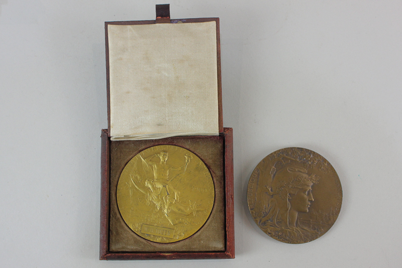 Two 1900 Paris Exposition Universelle medals comprising one gilt bronze, in original leather case,