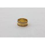 A gold and diamond ring, flat section with outer rows of round diamonds, 6.6g gross