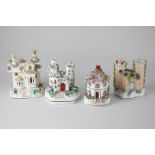 Two Staffordshire pottery models of castles, together with two Staffordshire pastille burners