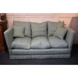 A three-seater Knole sofa with pale blue upholstery, hinged sides and oval finials, on platform base