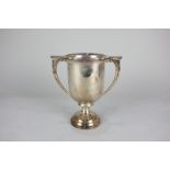 A George V silver two handled trophy cup on circular pedestal base, with presentation inscription,