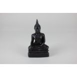 A carved hardwood figure of a seated Buddha, probably ironwood, 14.5cm high