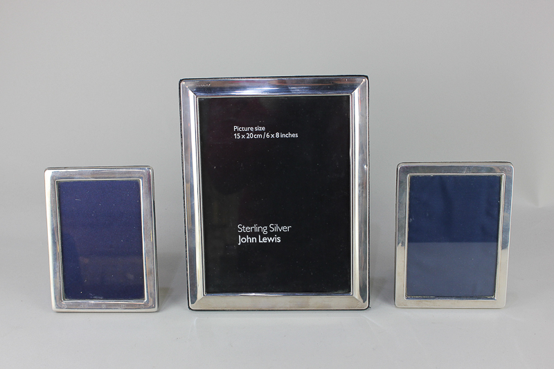 Three Elizabeth II silver photograph frames, two by Carr's of Sheffield, for pictures 20.5cm by 15.