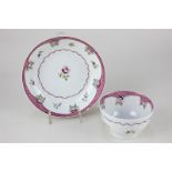 An 18th century English porcelain tea bowl and saucer with floral sprays and hatched pink border (