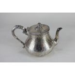 A Victorian silver teapot, circular baluster shape with engraved decoration, engraved initials to