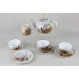 A Royal Worcester porcelain tea set decorated by James Stinton, decorated with birds including