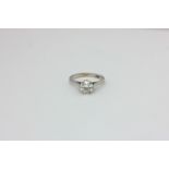 A diamond single stone ring, the round brilliant cut stone six-claw set in platinum