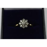 A diamond nine-stone cluster ring in 18ct white on yellow gold