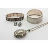A late Victorian silver locket on modern box link chain, a silver bangle, a Siamese silver and