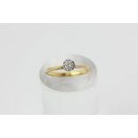 A diamond single stone ring, illusion set in 18ct white and yellow gold